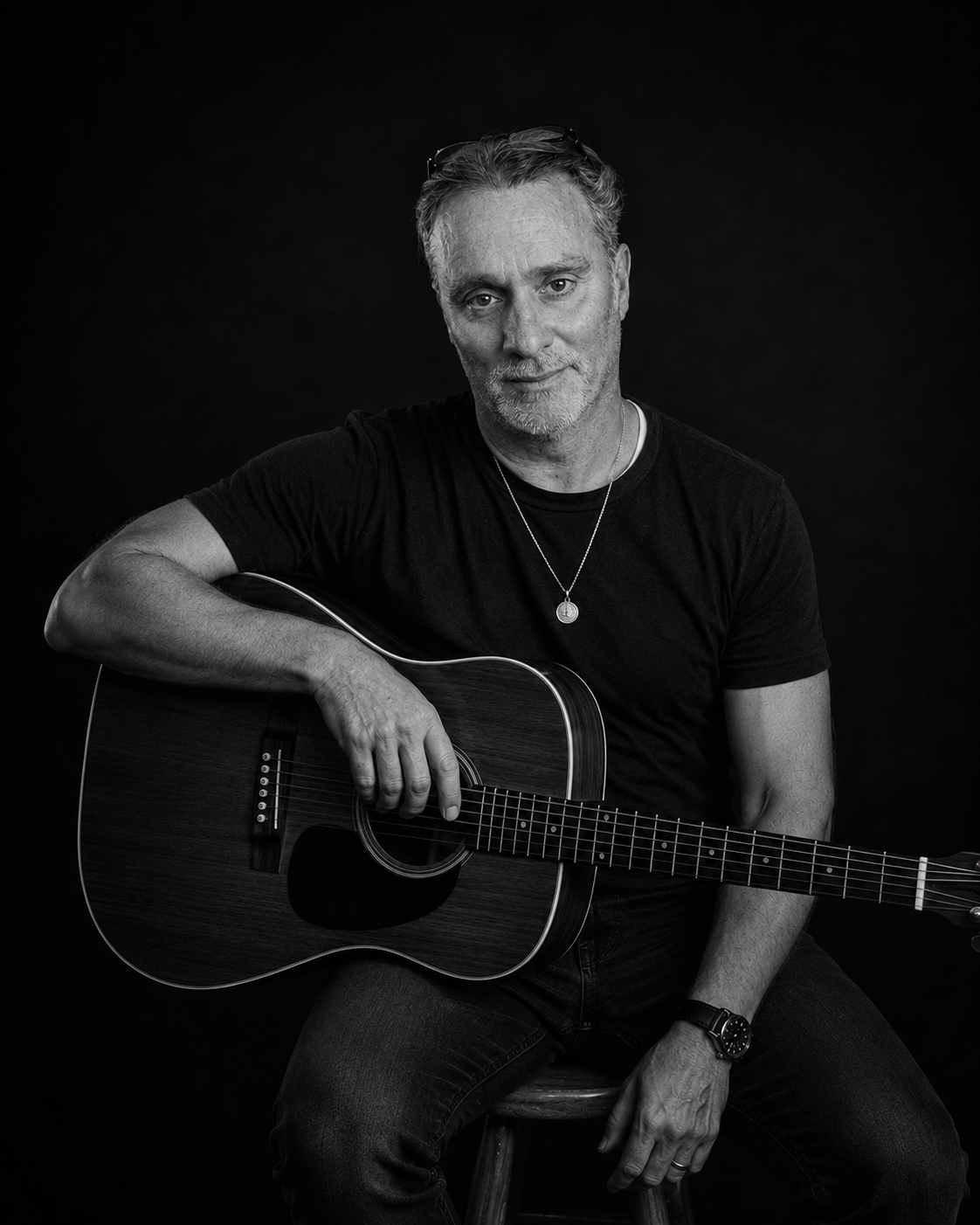 A. Howard North holding an acoustic guitar